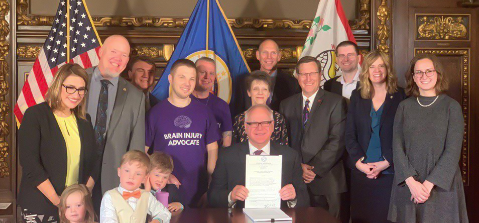 Governor Tim Walz and advocates signing bill into law