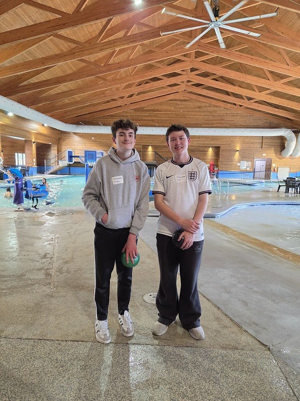 Attendees pose for photo by the pool in the waterpark