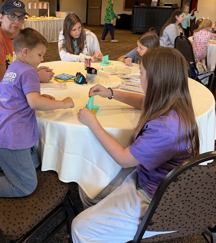 Families playing Connect Four games at the event and socializing